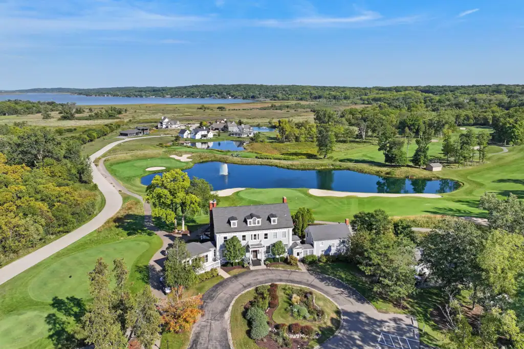Beautiful lake view with lush greenery and elegant homes.
