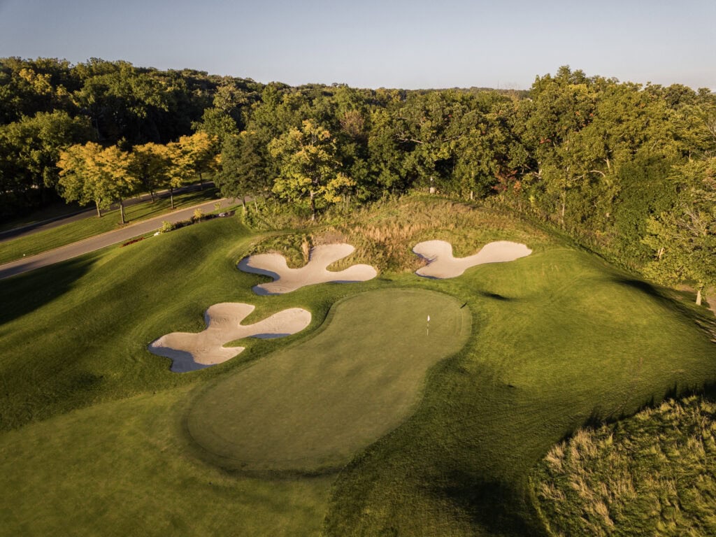 Golf course green with sand bunkers and surrounding trees at Lake Geneva.