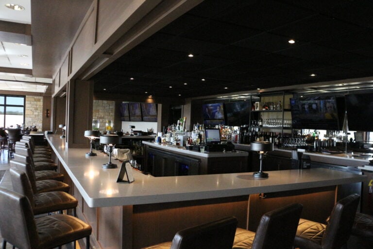 Modern bar with seating and drink options at Lake Geneva.