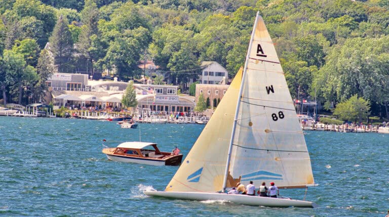 Sailboat racing in front of Gage Marine on Geneva Lake WI