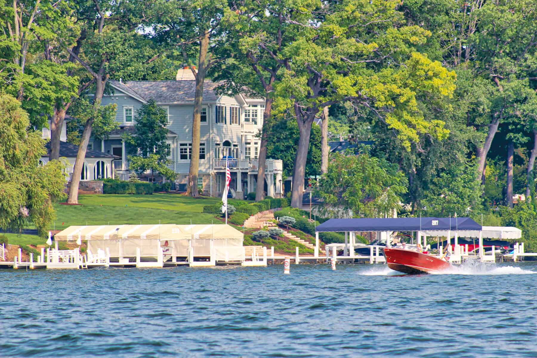 Beautiful lakeside homes with boat docks on Lake Geneva.