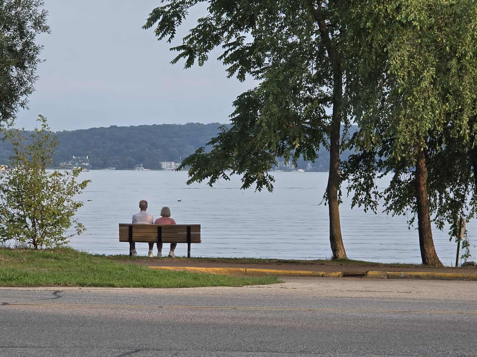 2 people on a bench looking out at Geneva Lake