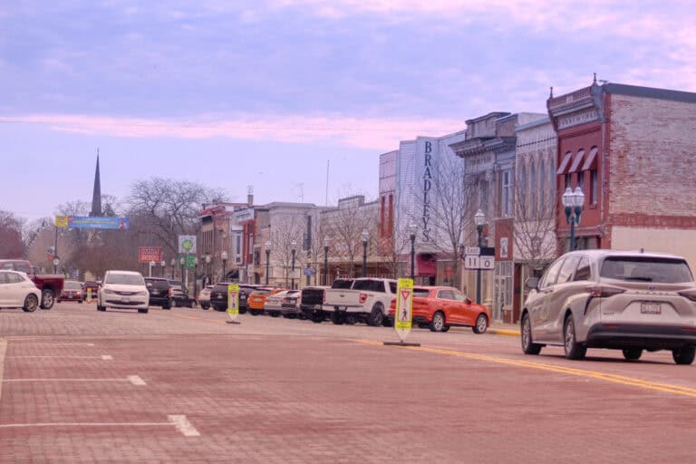 Downtown Delavan street with parked cars and historic buildings.