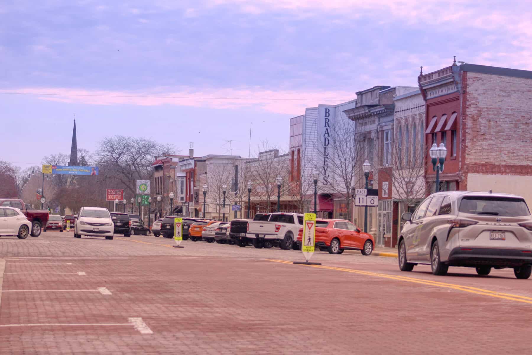 Downtown Delavan street with parked cars and historic buildings.