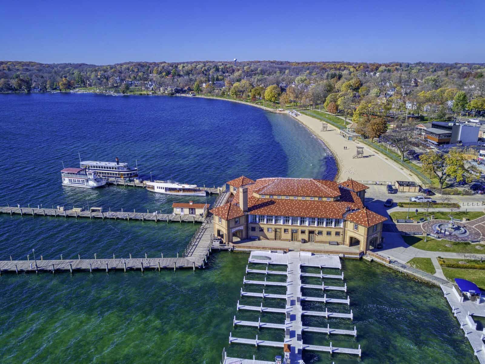 Aerial view of the Riviera and Riviera Beach in fall, with tour boats docked and fall color along the shoreline
