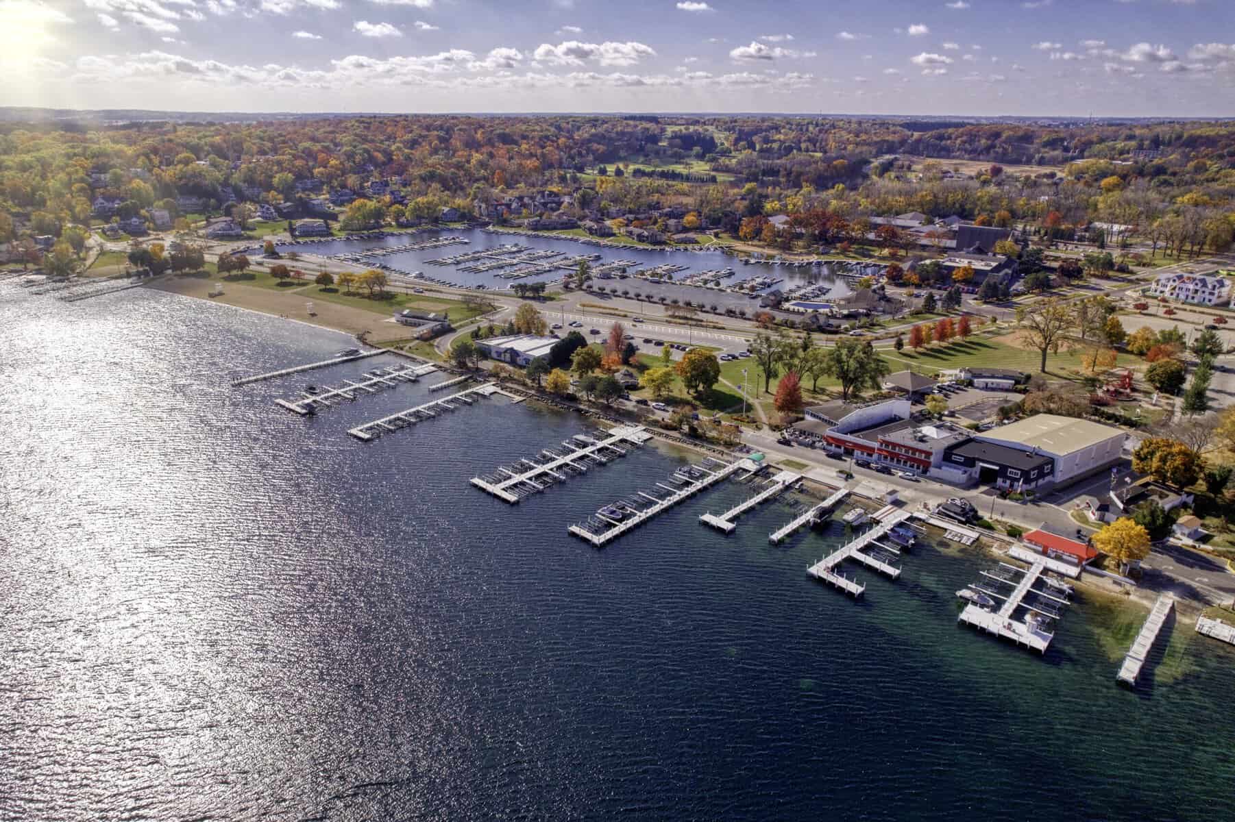 Aerial view of the Fontana lakefront in fall, with the Gordy's and Jerry's rental piers along Lake Street and a harbor behind
