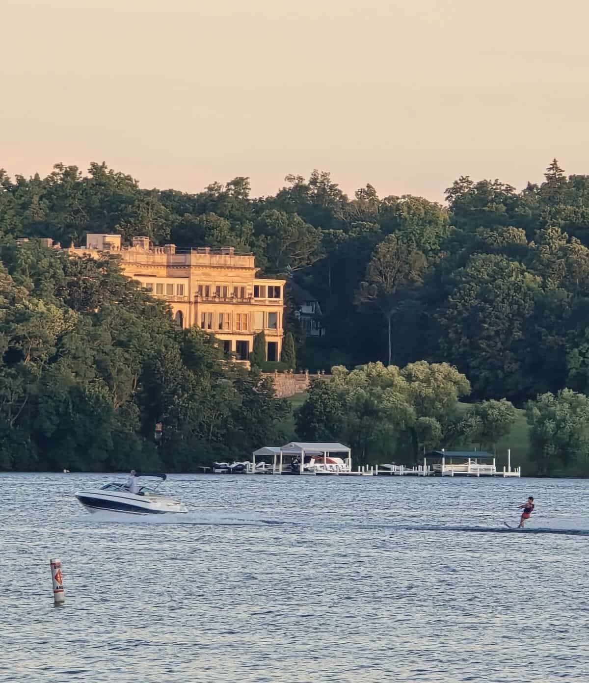 Water skier on Geneva Lake passing Stone Manor