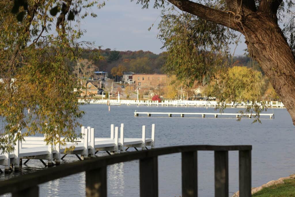 Waterfront view with docks and trees along Lake Geneva.