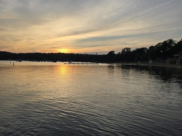 Beautiful sunset over Lake Geneva with calm waters and a scenic sky.